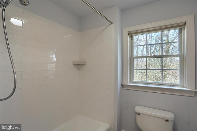 full bath with a wealth of natural light, bathtub / shower combination, and toilet