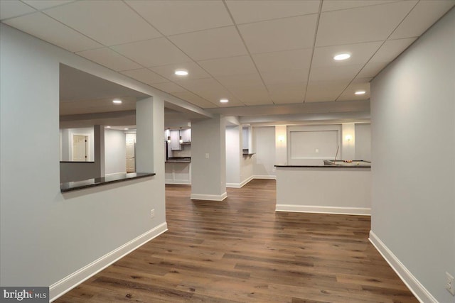 spare room featuring recessed lighting, dark wood finished floors, and baseboards