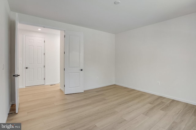 empty room with light hardwood / wood-style flooring