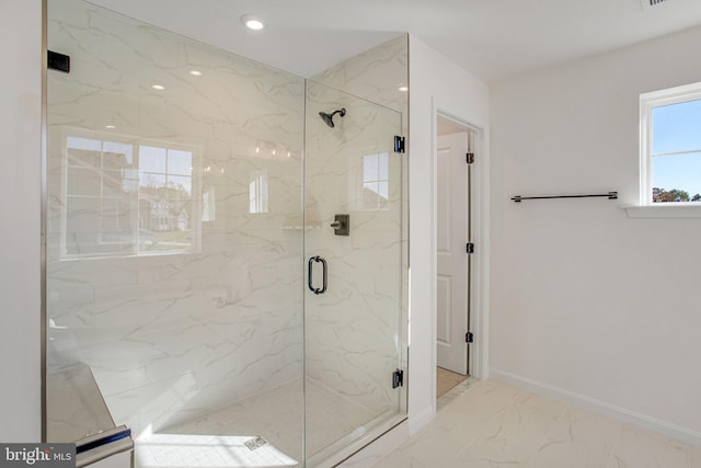 bathroom featuring a shower with door