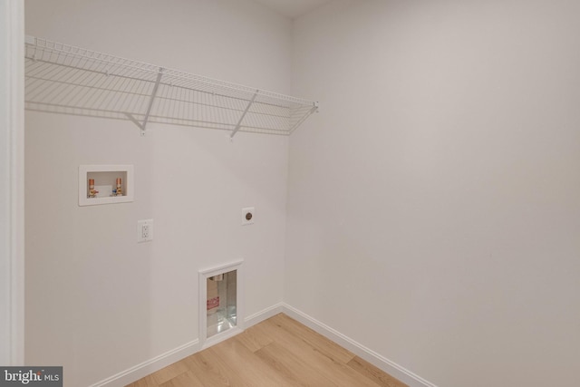 washroom with washer hookup, wood-type flooring, and electric dryer hookup