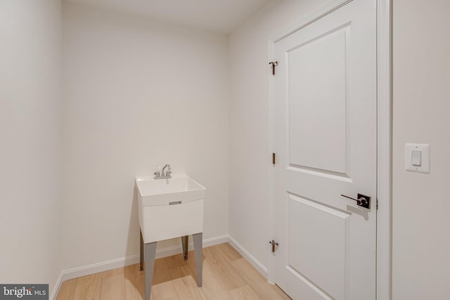 laundry area with light hardwood / wood-style flooring