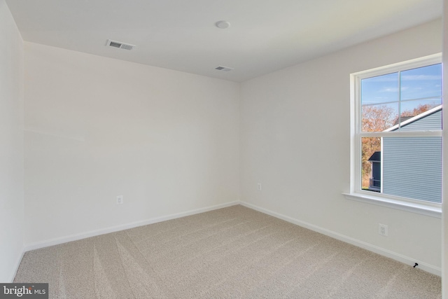 unfurnished room featuring carpet