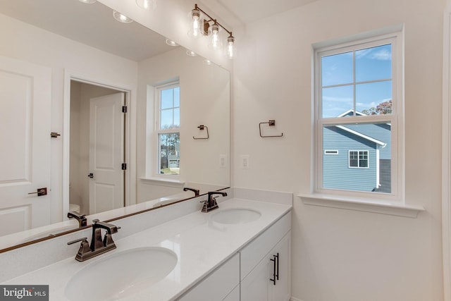 bathroom featuring vanity, toilet, and a wealth of natural light