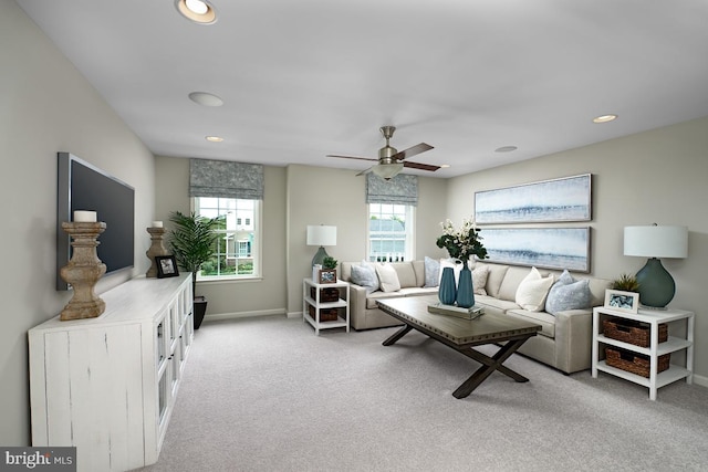 living room with light colored carpet and ceiling fan