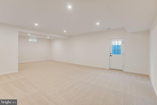 basement with plenty of natural light and light carpet