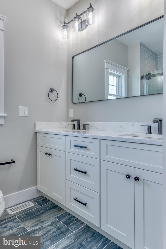 bathroom featuring vanity and walk in shower