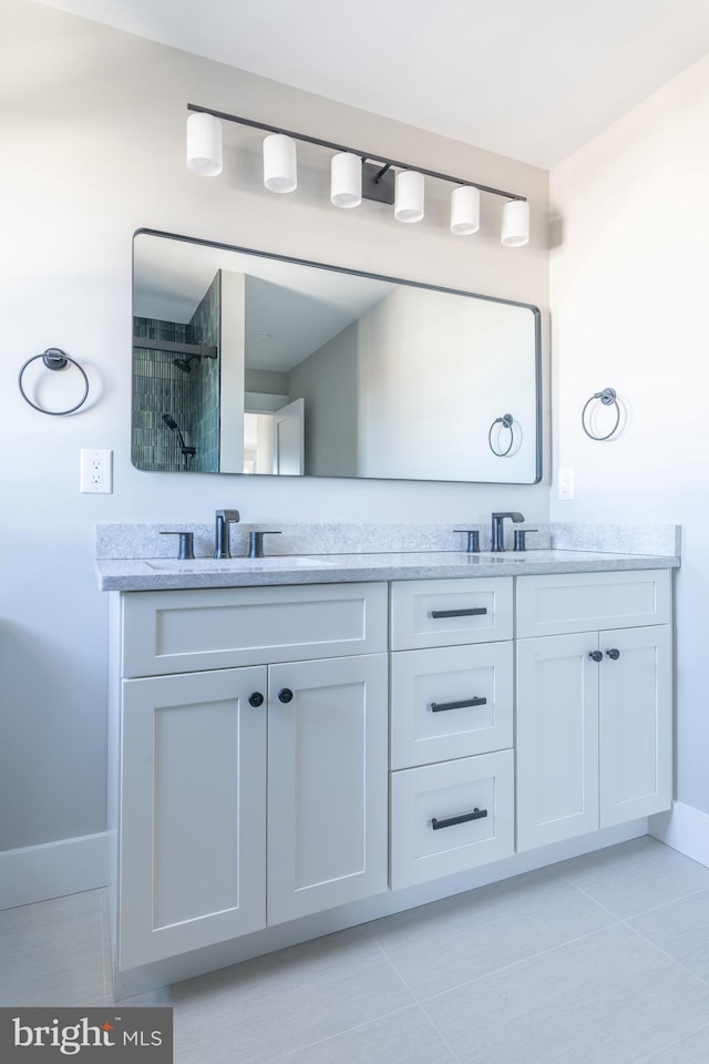 bathroom featuring tile patterned floors, a shower, and vanity