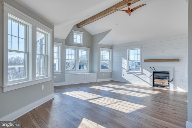 unfurnished living room featuring lofted ceiling with beams, ceiling fan, and wood-type flooring