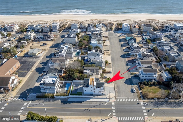 birds eye view of property with a view of the beach and a water view