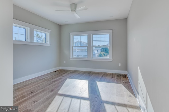 unfurnished room with ceiling fan and light wood-type flooring