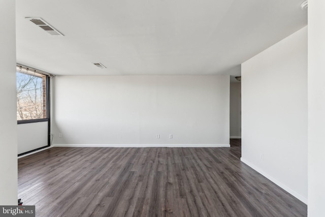 spare room with dark hardwood / wood-style flooring