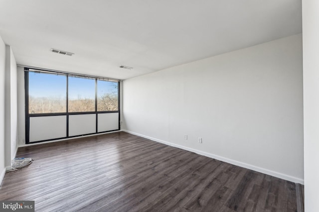 spare room with dark wood-type flooring