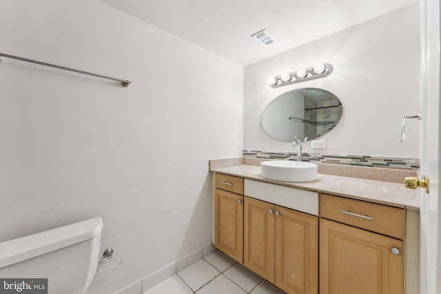 bathroom featuring toilet, vanity, and tile patterned floors