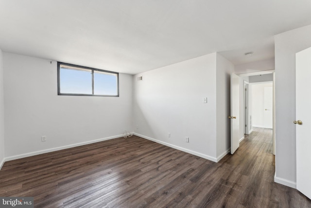 empty room featuring dark hardwood / wood-style flooring