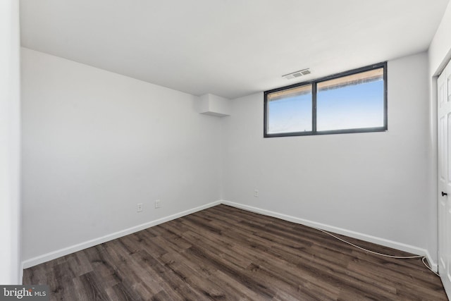 unfurnished room with dark hardwood / wood-style floors