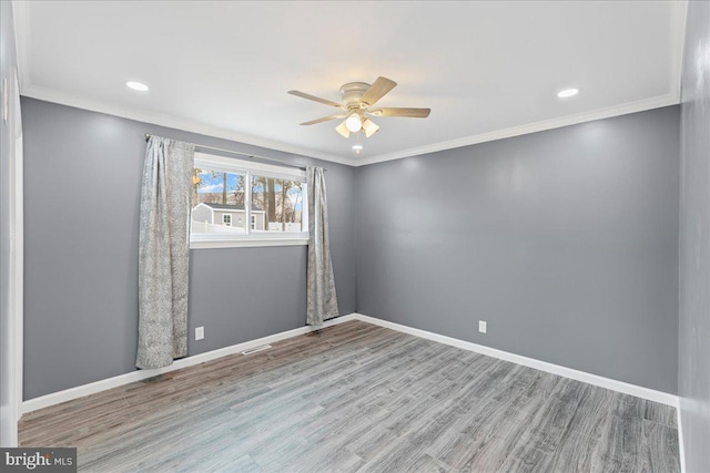 spare room with ornamental molding, light hardwood / wood-style floors, and ceiling fan