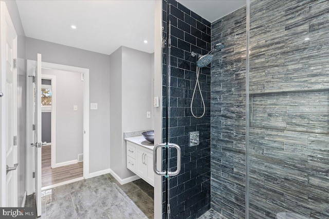 bathroom featuring vanity and a shower with shower door