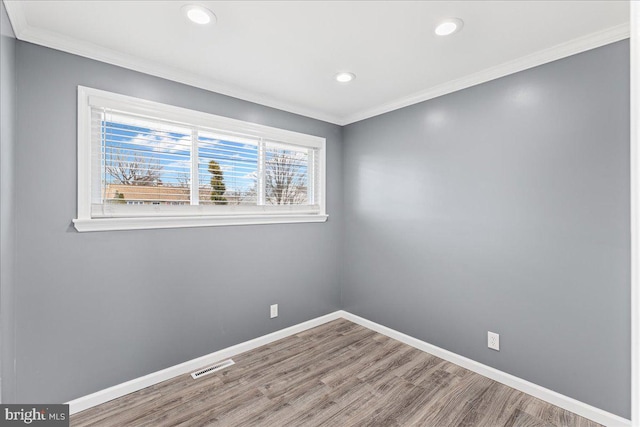 unfurnished room featuring crown molding and wood-type flooring