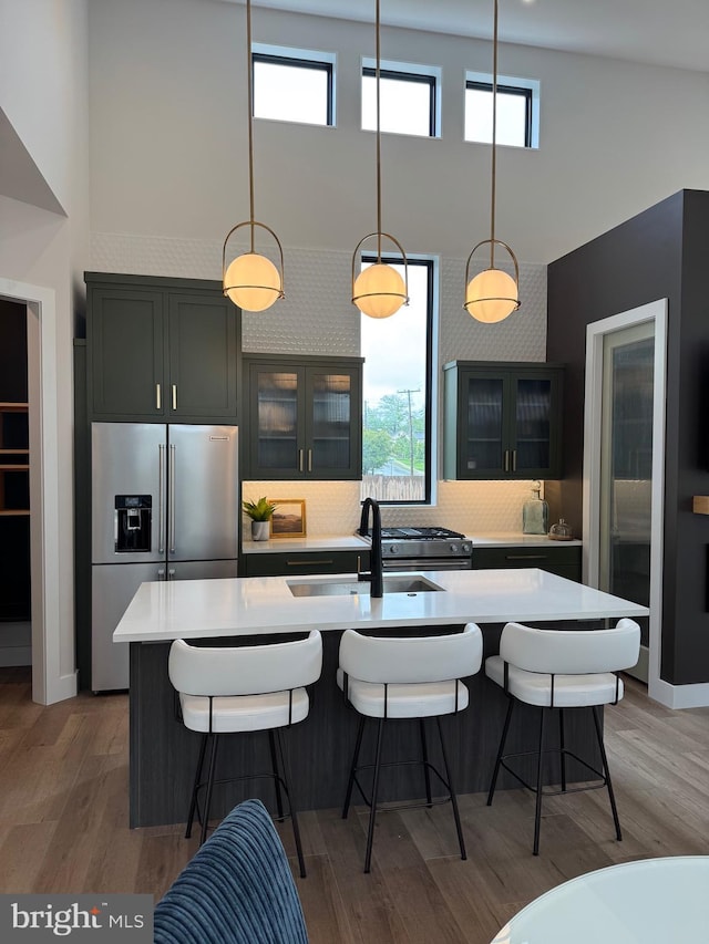 256 S Cedar St, Lititz, PA 17543 - kitchen featuring high end refrigerator, a high ceiling, light countertops, a breakfast bar area, and decorative light fixtures