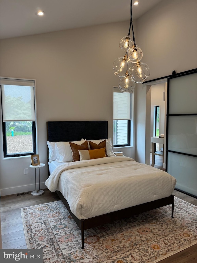 256 S Cedar St, Lititz, PA 17543 - bedroom with wood finished floors, recessed lighting, baseboards, and a barn door