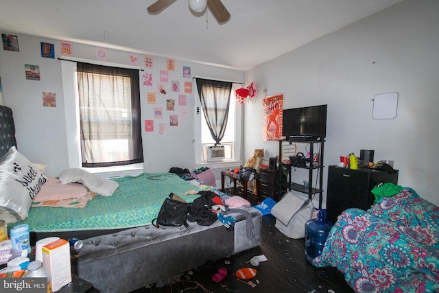 bedroom featuring ceiling fan, cooling unit, and wood-type flooring