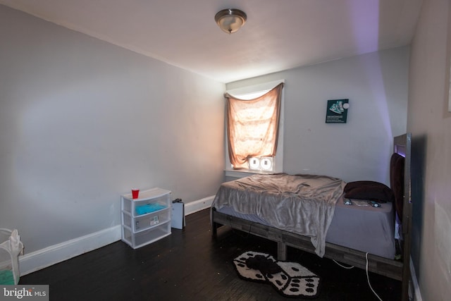 bedroom with dark hardwood / wood-style floors