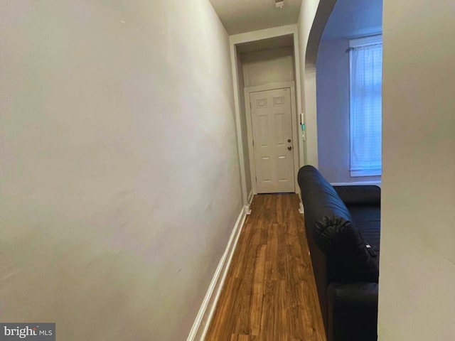 hallway with dark wood-type flooring