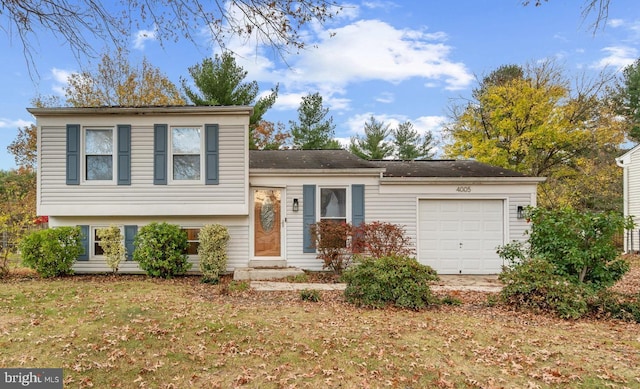 split level home with a garage and a front yard