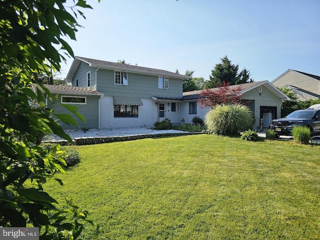 rear view of house featuring a lawn