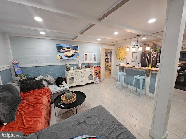 living room featuring beam ceiling and light wood-type flooring