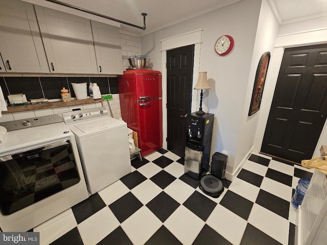 laundry room with washer and clothes dryer and cabinets