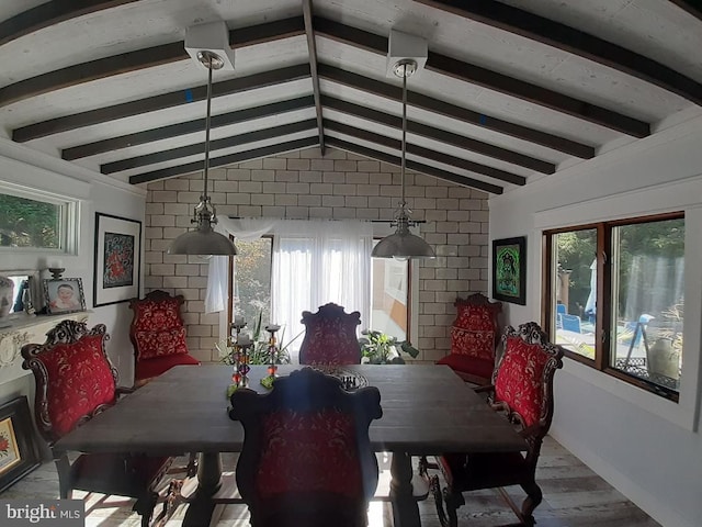 dining space featuring vaulted ceiling with beams and light hardwood / wood-style floors