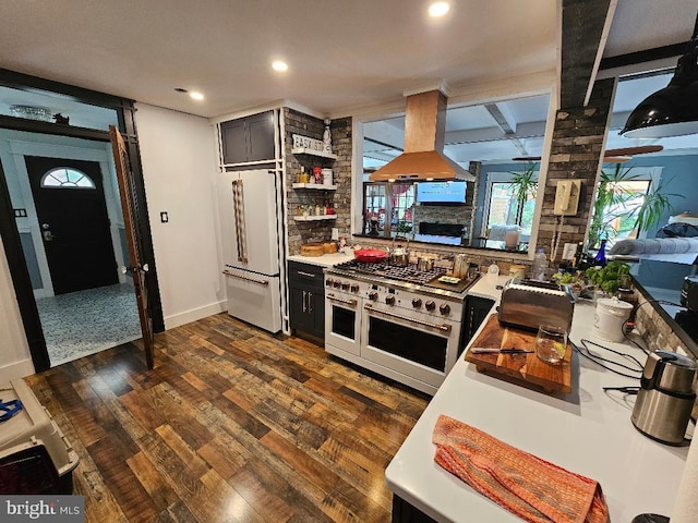 kitchen featuring island exhaust hood, dark hardwood / wood-style flooring, premium appliances, and beamed ceiling