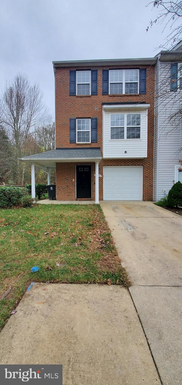 view of property featuring a garage and a front yard