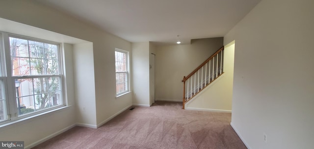 interior space featuring light carpet