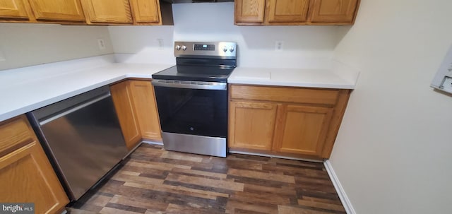 kitchen featuring appliances with stainless steel finishes and dark hardwood / wood-style flooring