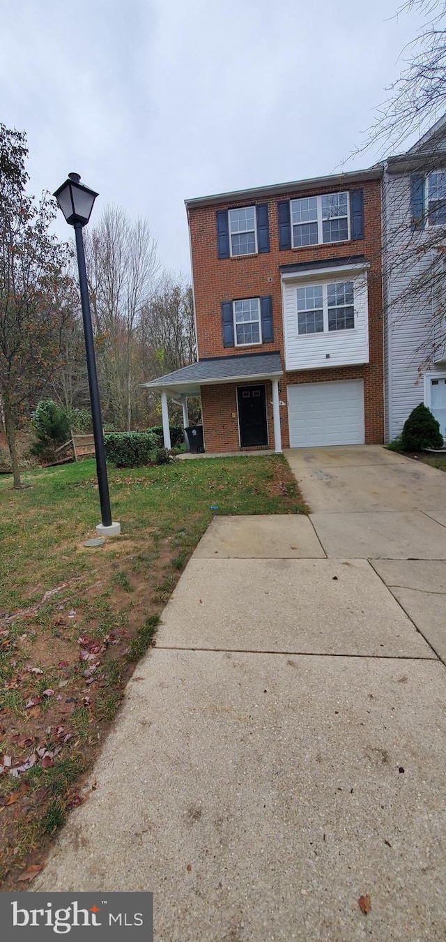 view of property with a front yard and a garage