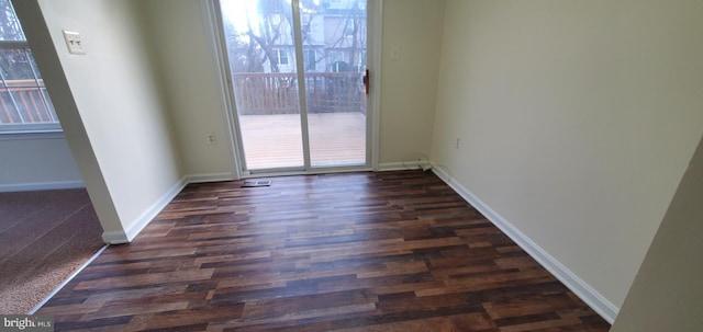 spare room featuring dark wood-type flooring