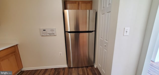 kitchen with stainless steel refrigerator and dark hardwood / wood-style flooring