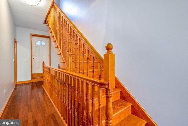 staircase with hardwood / wood-style floors