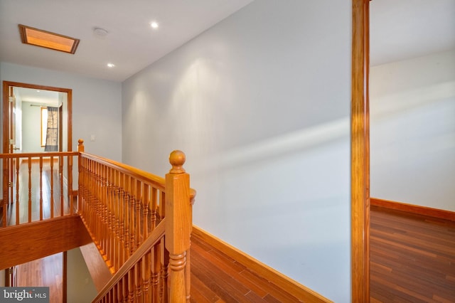 staircase featuring wood-type flooring