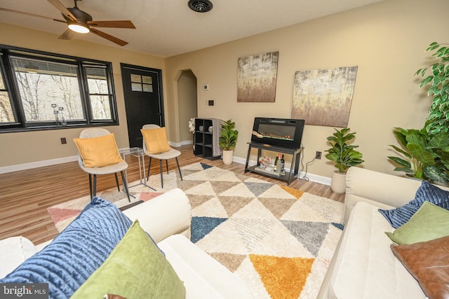 living room with hardwood / wood-style flooring and ceiling fan