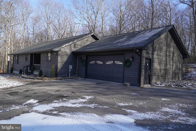 view of snow covered exterior featuring a garage