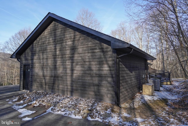 view of snowy exterior featuring cooling unit