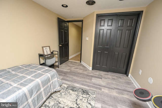 bedroom featuring light wood-type flooring and a closet