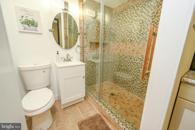 bathroom with walk in shower, tile patterned floors, vanity, and toilet