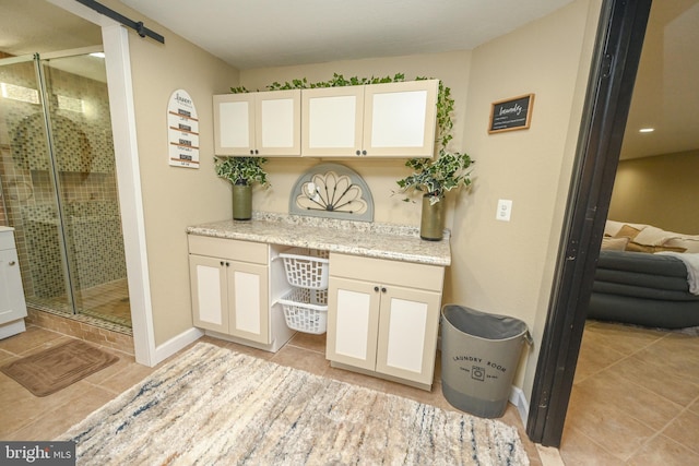 bathroom featuring vanity, tile patterned floors, and an enclosed shower