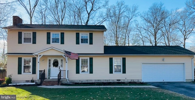 view of front facade featuring a garage and a front lawn