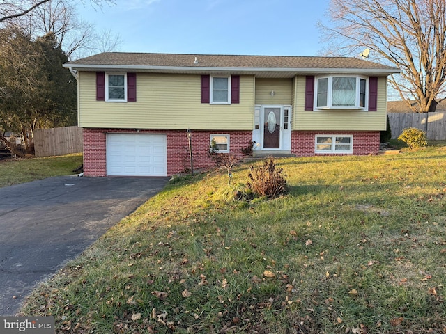 bi-level home with a front lawn and a garage